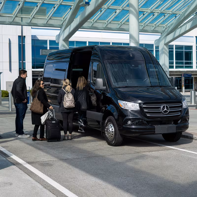 Group boarding a white charter bus for Airport Transportation transportation in Norfolk