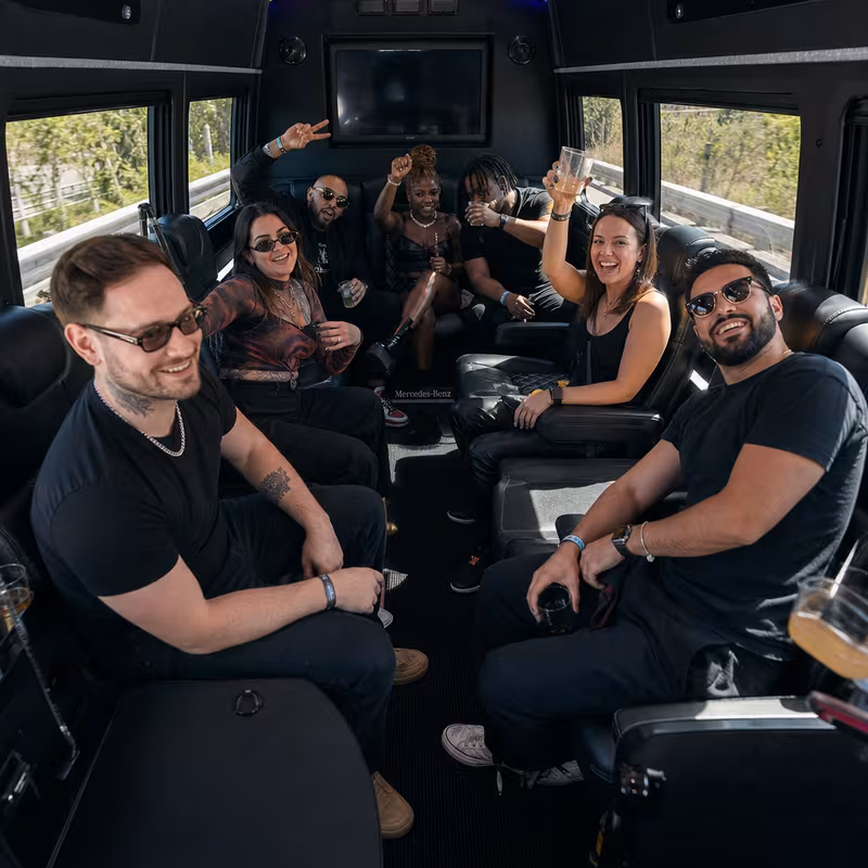Group boarding a white charter bus for Concert Transportation transportation in Norfolk