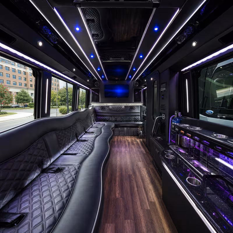 Party bus interior with wraparound leather seating and LED lighting in Norfolk