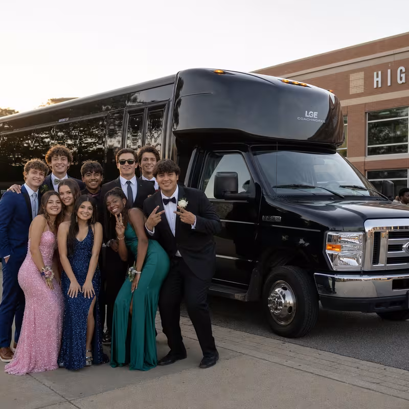 Group boarding a white charter bus for Prom & Homecoming Transportation transportation in Norfolk