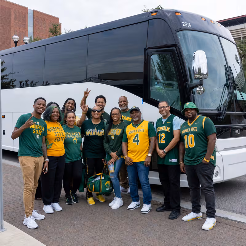 Passengers loading luggage while boarding an Norfolk group shuttle