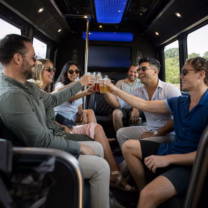 Group boarding a white charter bus for Winery & Brewery Tour Transportation transportation in Norfolk