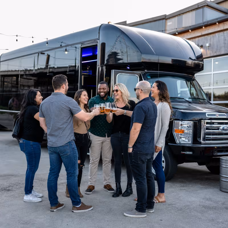 Passengers loading luggage while boarding an Norfolk group shuttle